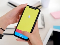 Woman holding a iPhone X with social network service Snapchat on the screen. iPhone X was created and developed by the Apple inc. Snapchat application on iPhone X